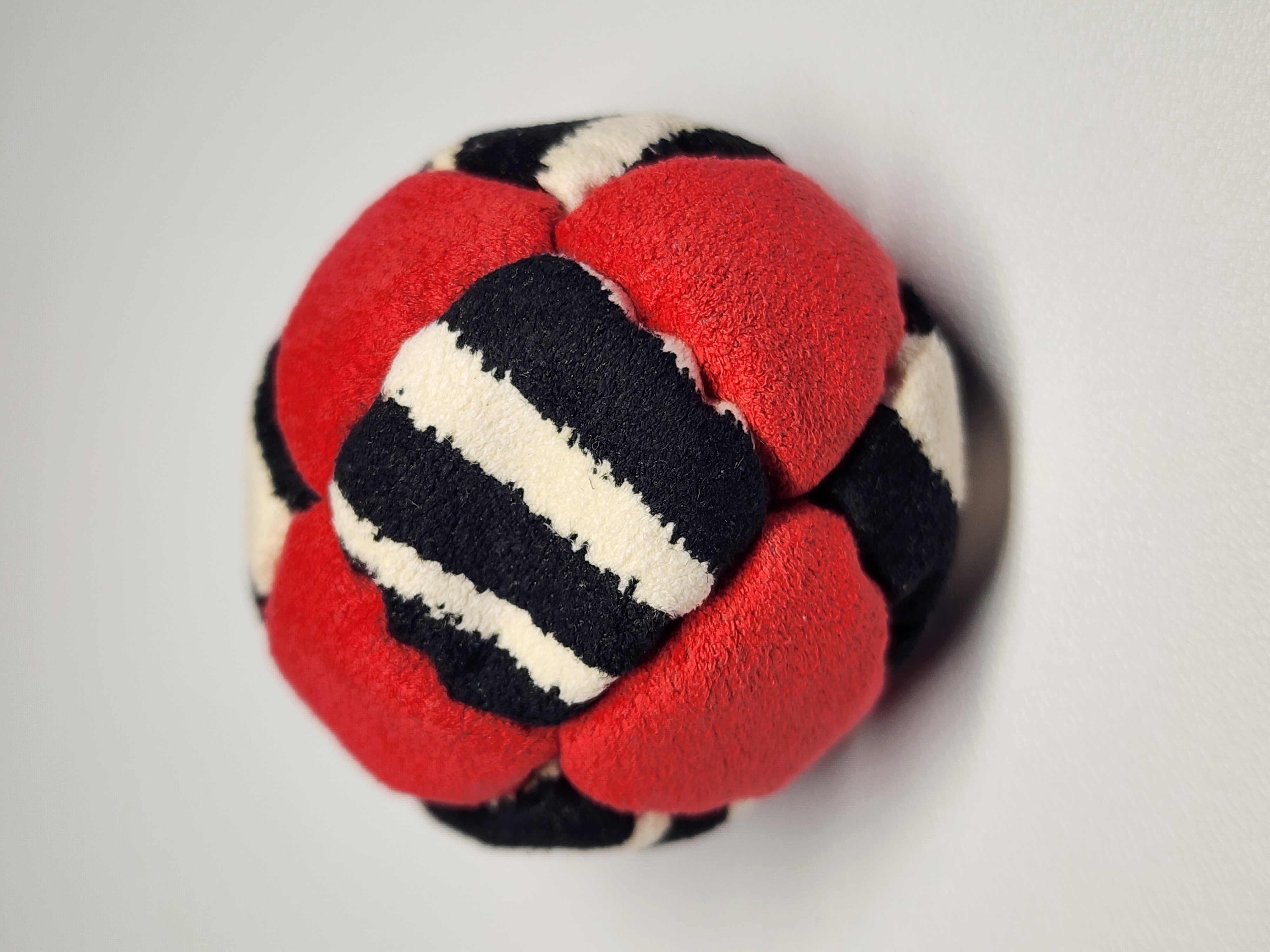 14-Panel Freestyle Footbag by Hacky Snack (#4) — Stitched by freestyle player Hacky Snack. 14-panel footbag (1.9 inch, 65g) made with Ultrasuede LT panels and zinc plated steel fill. Built by a player who knows what a good bag feels like.