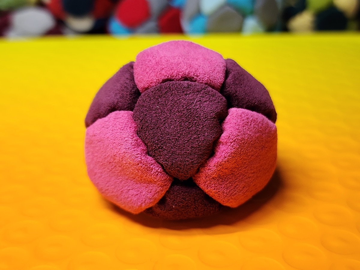 14-Panel Footbag by Hacky Snack (#33) — Stitched by freestyle player Hacky Snack. The real deal — made from Ultrasuede LT, hand-stitched by a player, tuned for freestyle. 14 panels, 1.8 inch, 67g.
