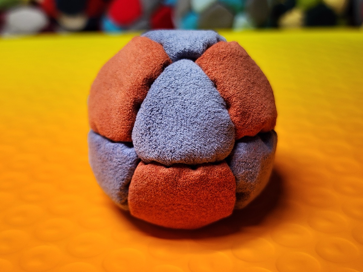 14-Panel Footbag by Hacky Snack (#38) — Stitched by freestyle player Hacky Snack. The real deal — made from Ultrasuede LT, hand-stitched by a player, tuned for freestyle. 14 panels, 1.8 inch, 67g.
