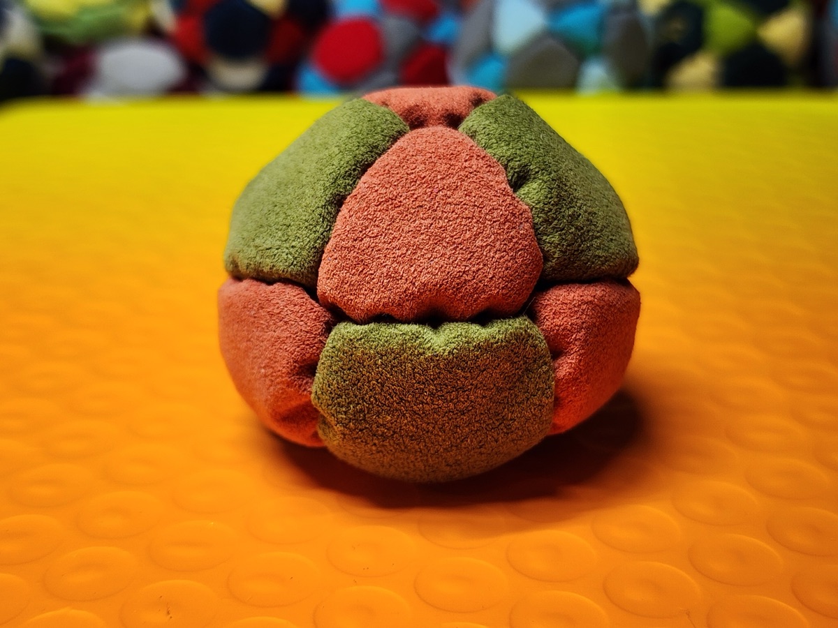 14-Panel Footbag by Hacky Snack (#41) — Stitched by freestyle player Hacky Snack. The real deal — made from Ultrasuede LT, hand-stitched by a player, tuned for freestyle. 14 panels, 1.8 inch, 67g.